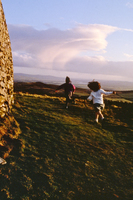 Children running Celtic circle Grianan of Aileach Donnegal Ireland